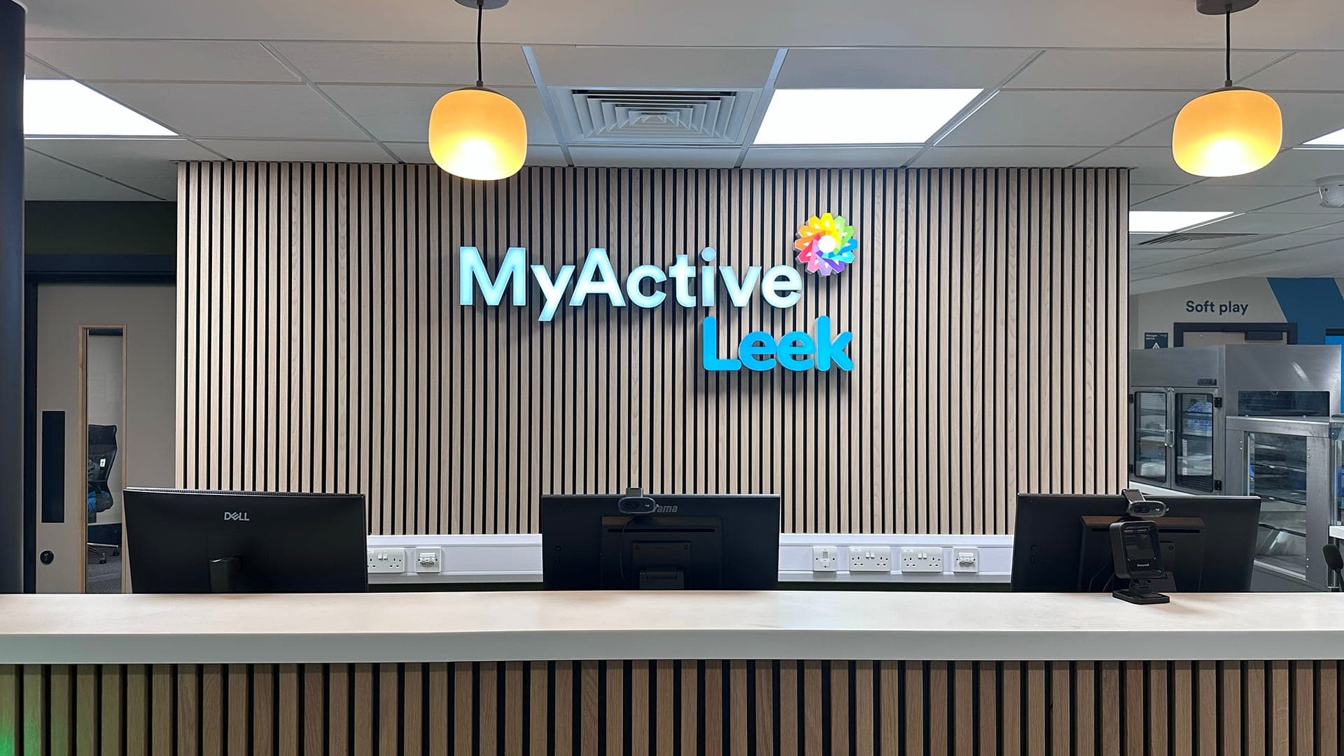MyActive Leek reception — illuminated lettering on fluted backdrop