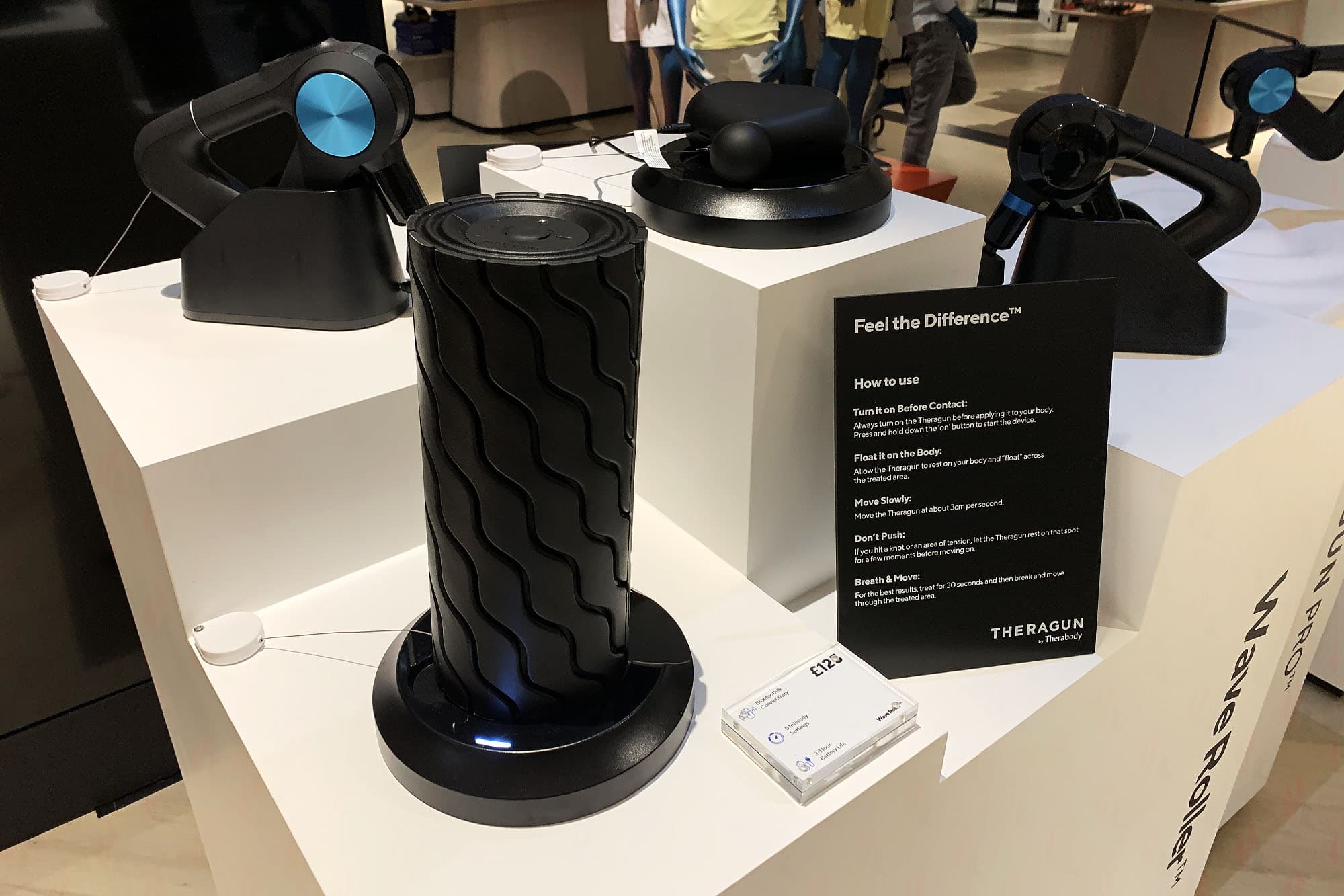 Five Therabody product plinths with Wave Roller, Theraguns and Feel the Difference instructional panel